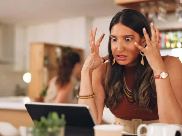 Stress, angry and woman on a laptop in a cafe working on a creative freelance project. Frustrated,