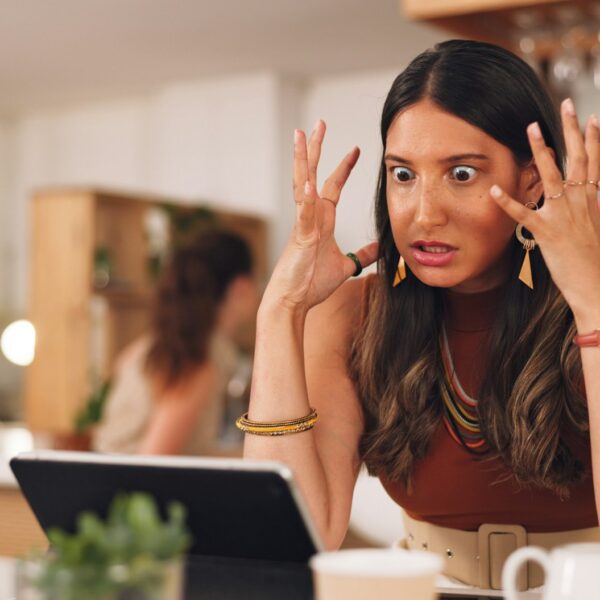 Stress, angry and woman on a laptop in a cafe working on a creative freelance project. Frustrated,